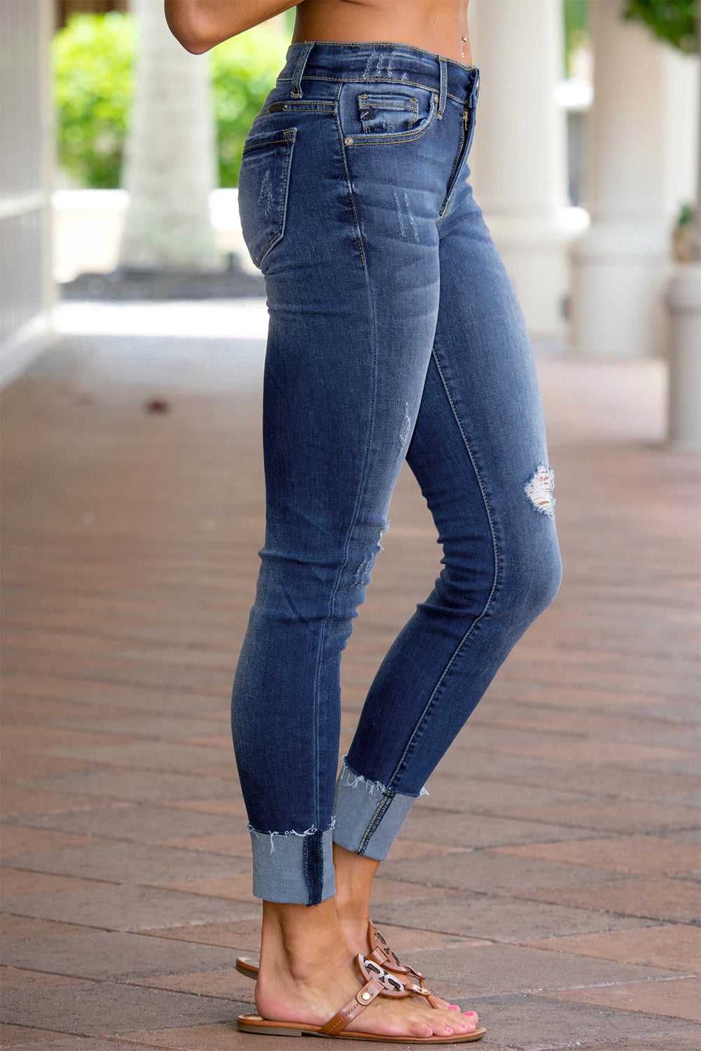 Model wearing Chic Women's Distressed Skinny Raw Hem Jeans side view