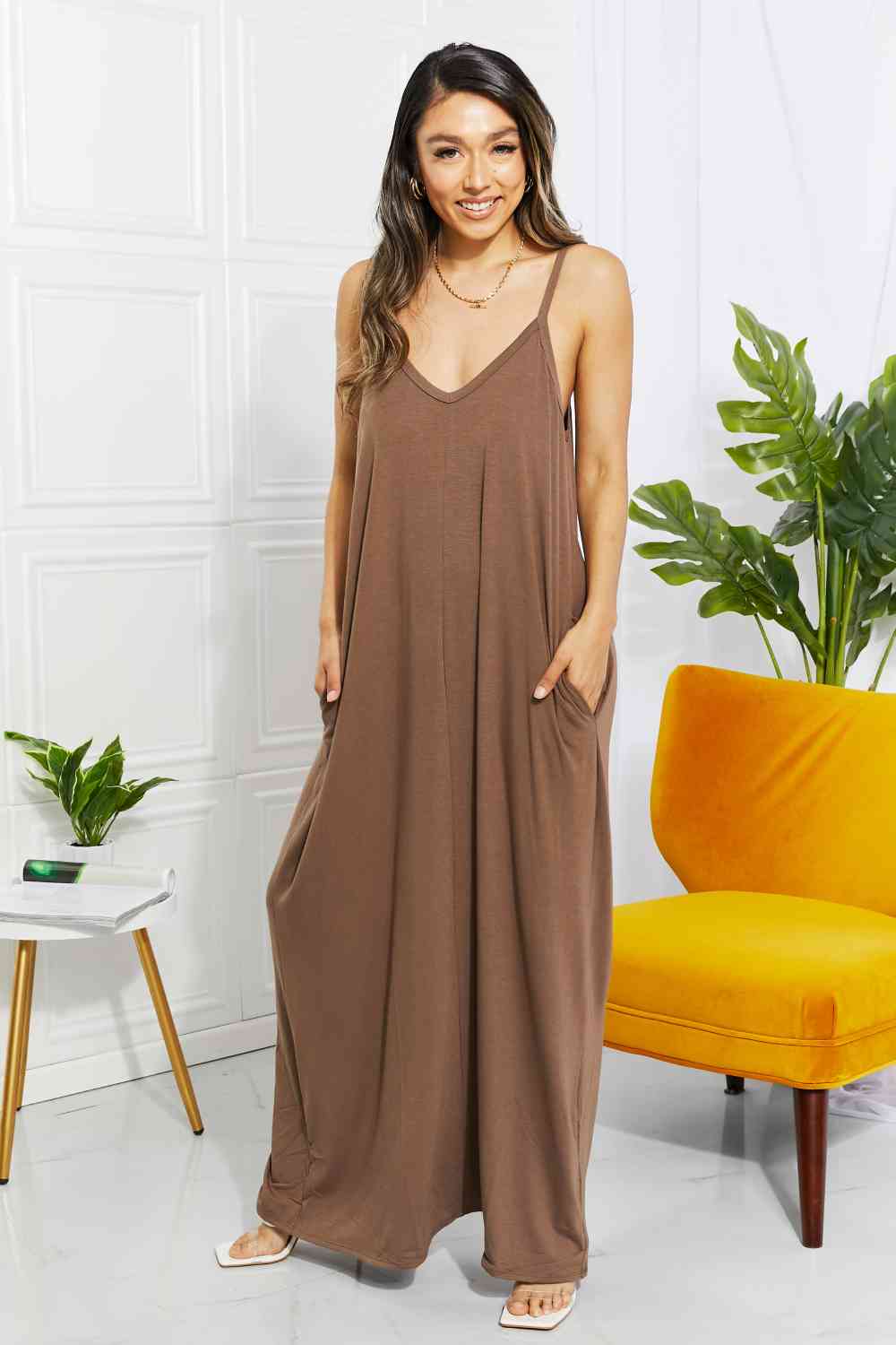 Experience beachy vibes with our Women's Casual Zenana Beach Vibes Cami Maxi Dress. Featuring a middle seam, adjustable straps, and soft stretchy fabric, this summertime essential is available in various colors. Wear it alone, pair it with a bralette or cardigan, or use it as a stylish cover-up. Don't forget, it comes with convenient pockets!