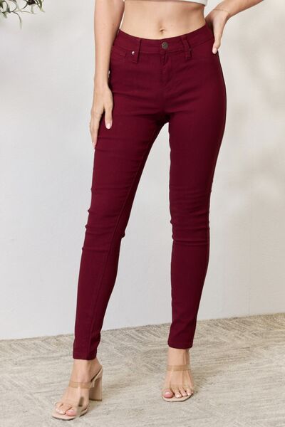 Model wearing a pair of Dark Wine Ladies YMI Hyperstretch Mid-Rise Skinny Jeans