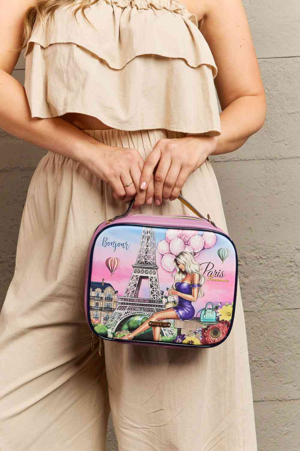 Model holding a Nicole Lee Contemporary Women's Romance in Paris Printed Handbag close up