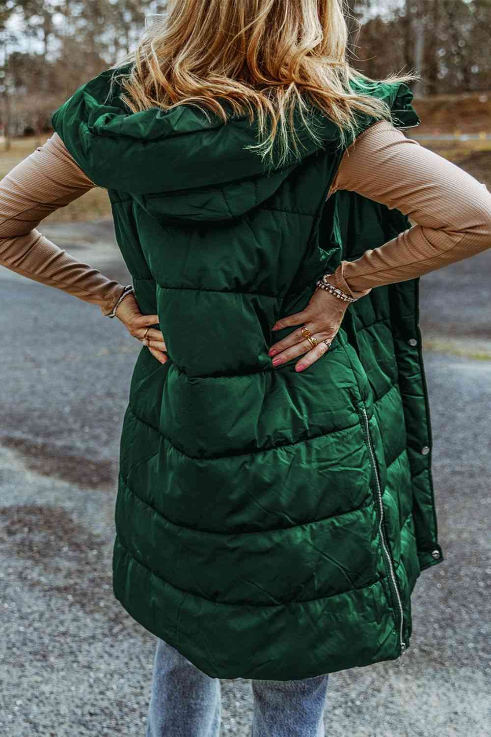 Back view a model wearing a Green Women's Posh Sleeveless Longline Hooded Puffer Vest