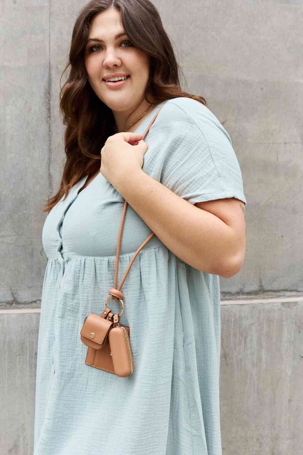 Model wearing a Brown Fabulous Women's Vegan Leather 3-Piece Lanyard Set off shoulder 