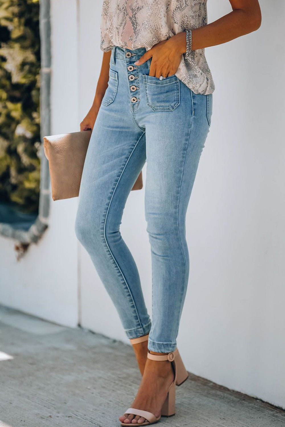 A model wearing a pair of Women's Light Blue Chic Button Fly Skinny Jeans