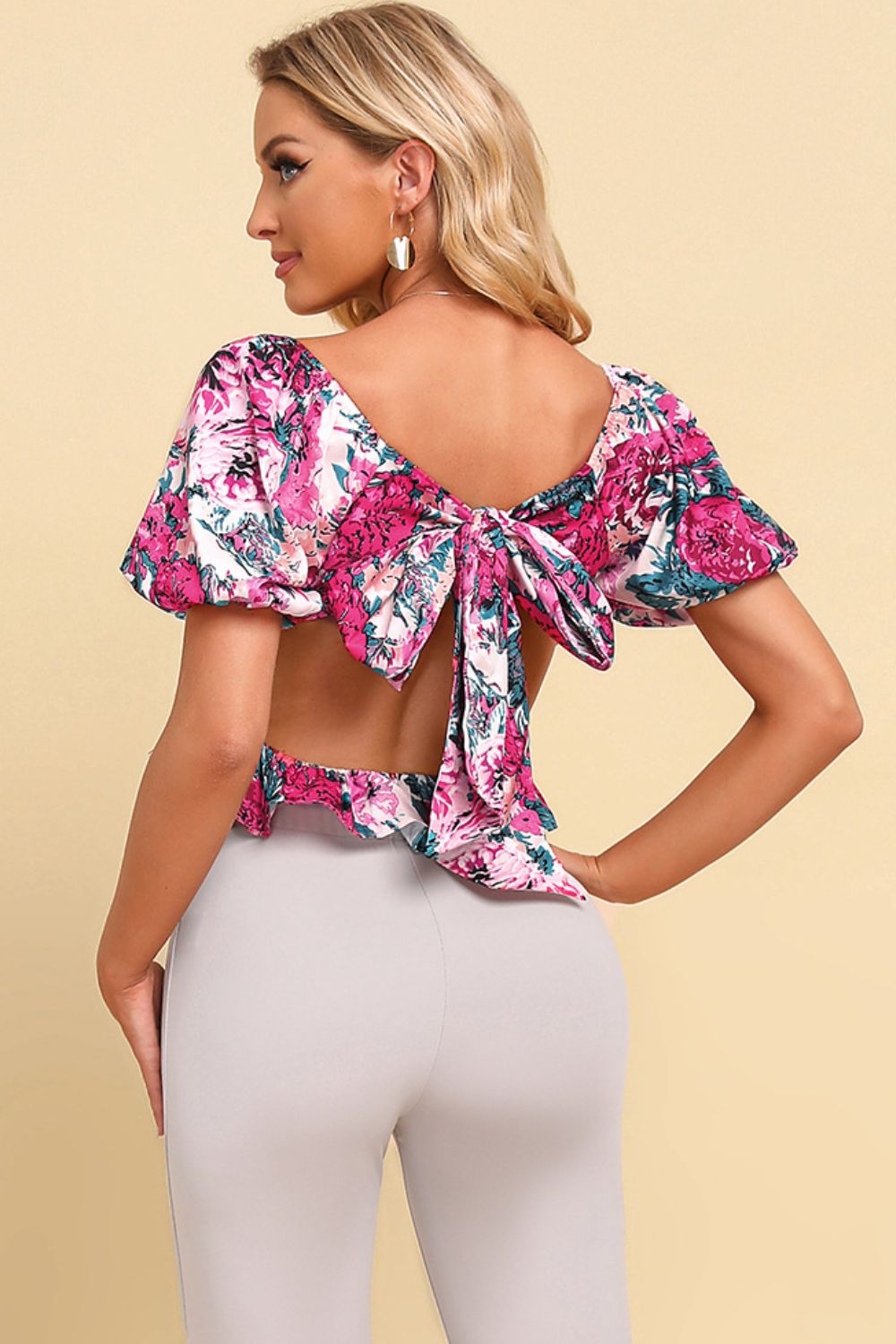 Back view of a Model wear a Ladies Summer Floral Tied Cropped Peplum Blouse