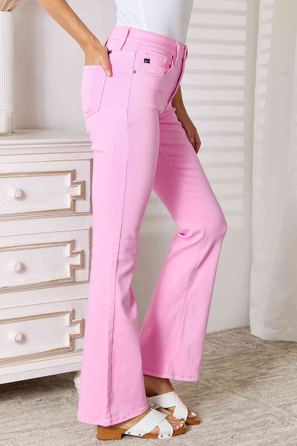Side view of model wearing Chic Kancan High Rise Carnation Pink Bootcut Jeans