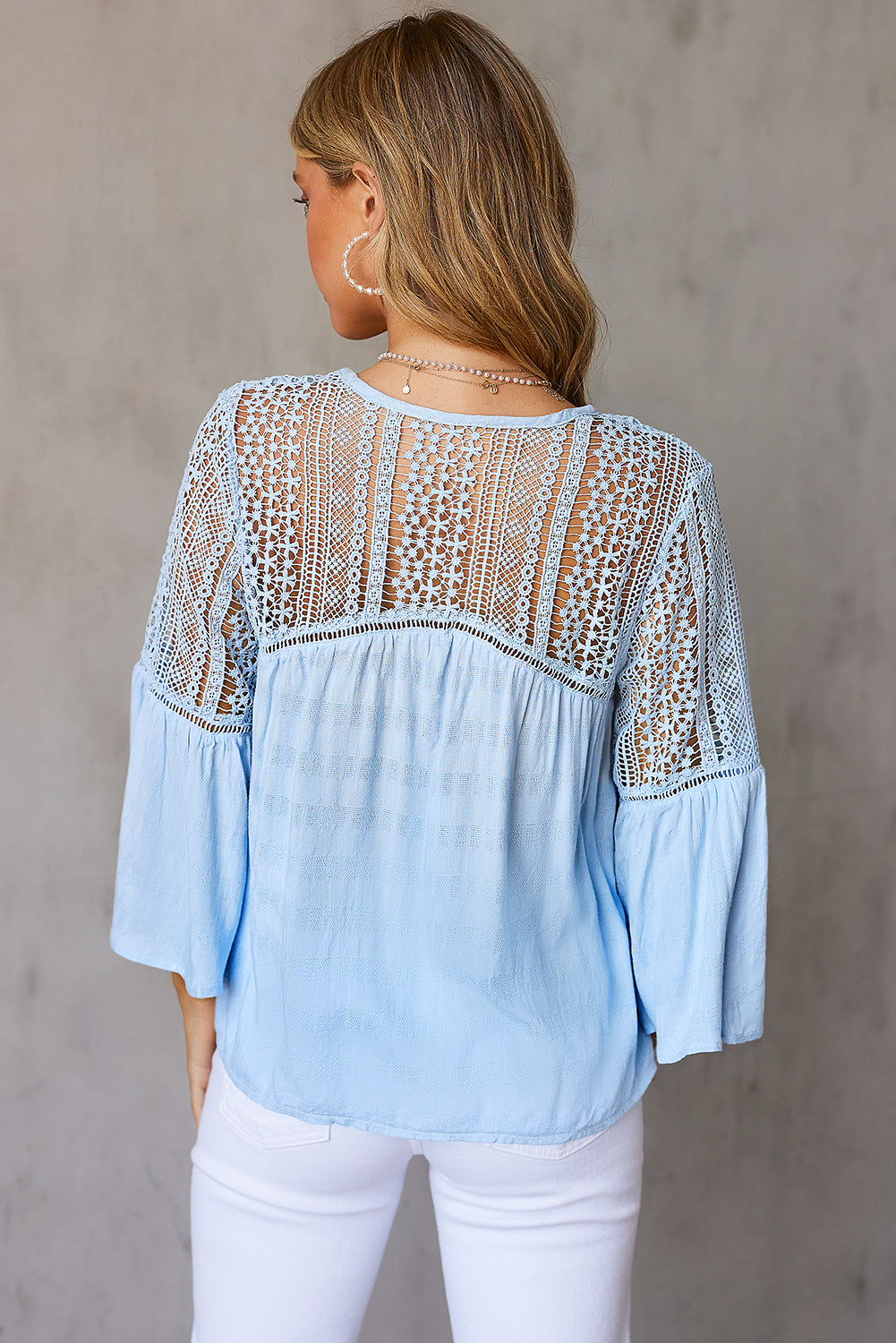 Back view of a Model wearing a Pastel Blue Stylish Flare Women's Sleeve Lace V-Neck Shirt 