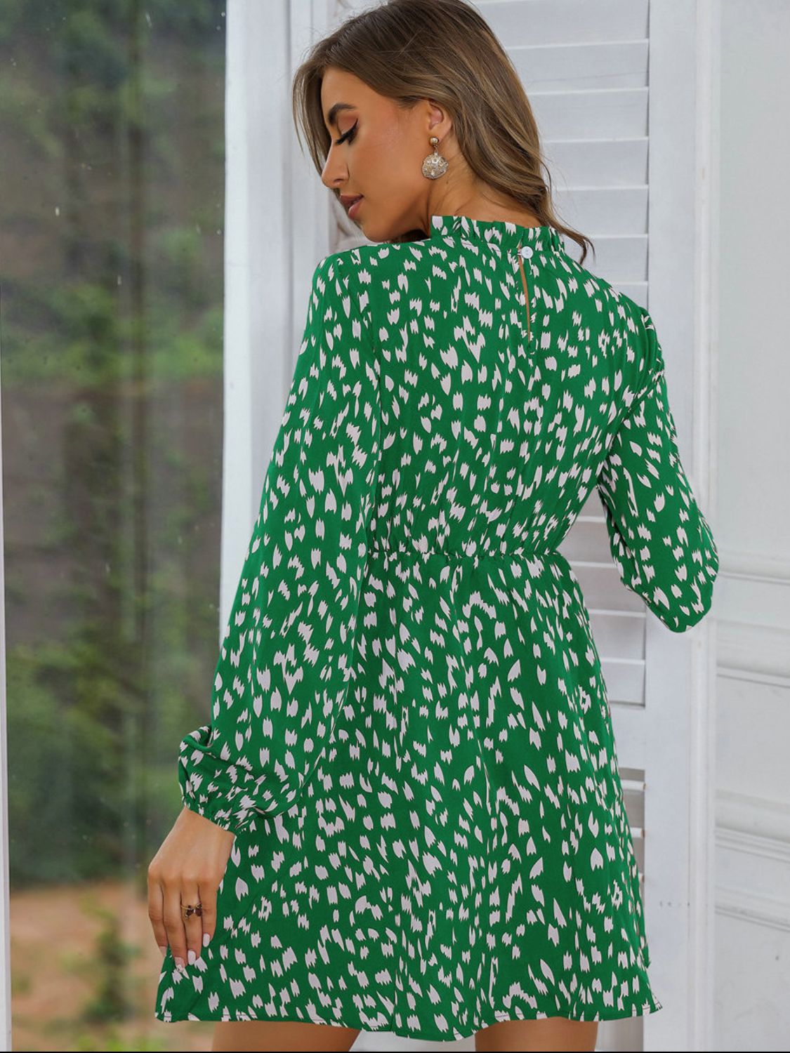 Back view of a Model wearing a Stylish and Comfortable Green Ladies Printed Frill Neck Long Sleeve Dress